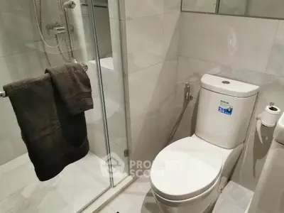 Modern bathroom with sleek shower and contemporary toilet design.