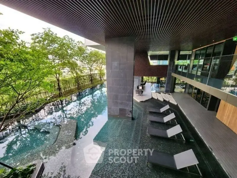 Luxurious modern pool area with sleek design and lush greenery