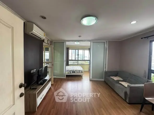 Spacious living room with modern decor and large windows offering natural light.