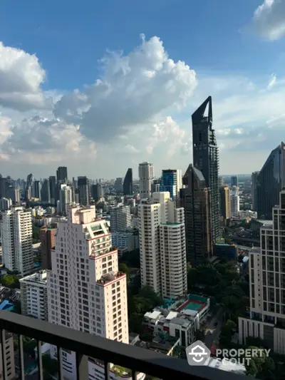 Stunning cityscape view from high-rise balcony with modern skyscrapers and blue sky