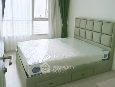 Modern bedroom with large window and stylish bed in a high-rise apartment.