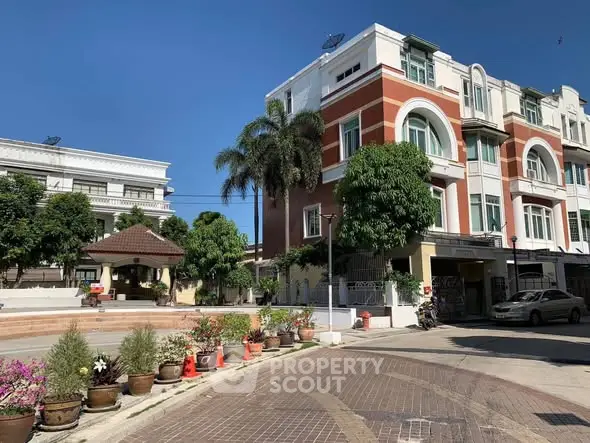 Charming residential building with lush greenery and clear blue sky