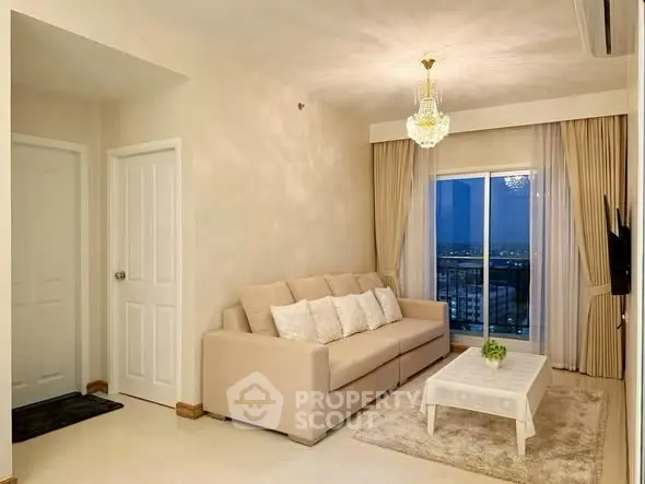 Elegant living room with chandelier and city view from balcony