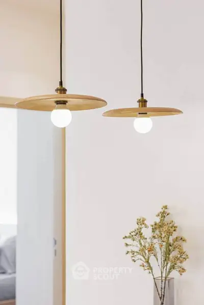 Elegant interior with modern pendant lights and subtle floral decor, perfect for stylish living spaces.