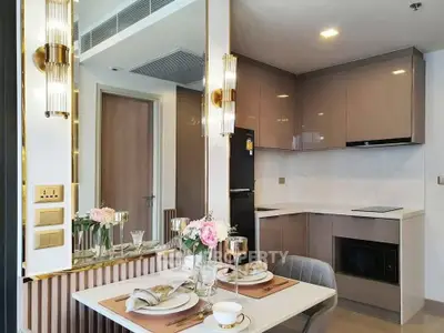 Luxurious modern kitchen with elegant dining setup and sleek cabinetry