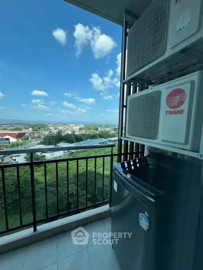 Stunning balcony view with lush greenery and cityscape, featuring modern air conditioning units.