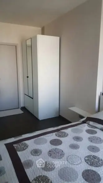 Cozy bedroom with modern wardrobe and stylish bedding