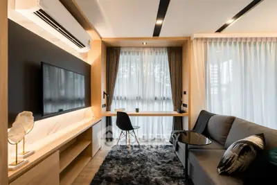 Modern living room with sleek furniture and large window, featuring a cozy sofa and stylish decor.