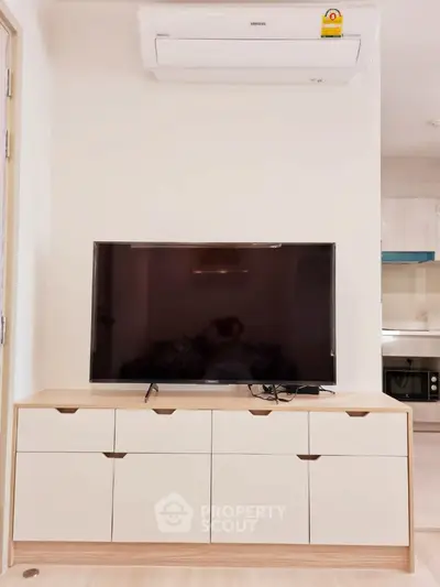 Modern living room with sleek TV setup and air conditioning