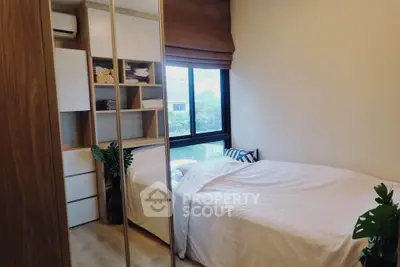 Cozy bedroom with mirrored wardrobe and large window view