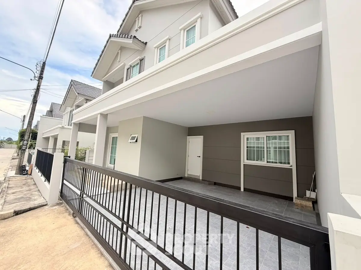 Modern townhouse exterior with spacious driveway and sleek design