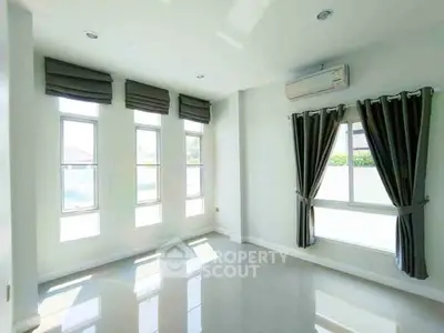 Bright and airy room with large windows and modern curtains, perfect for natural light lovers.