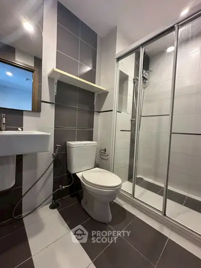 Modern bathroom with sleek shower and contemporary fixtures in stylish apartment.