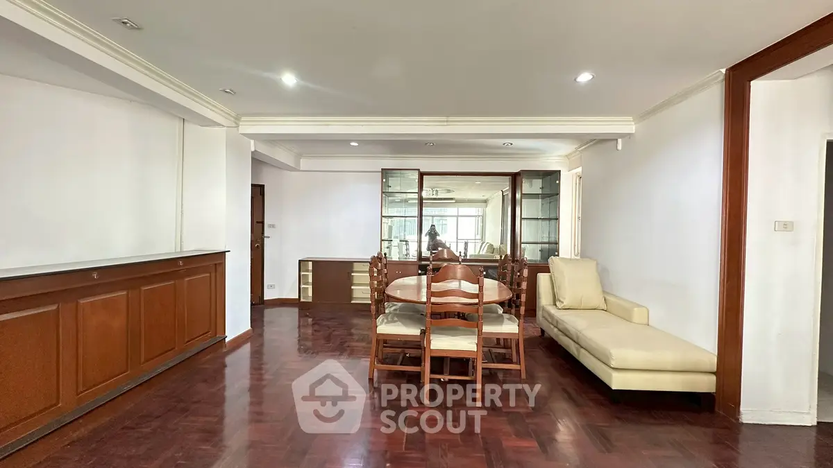 Spacious dining area with elegant wooden flooring and modern furniture