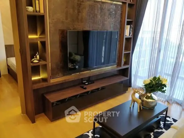 Luxurious living room with modern TV setup and elegant decor in a stylish apartment.