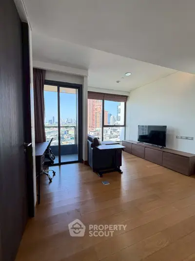 Modern living room with city view, featuring sleek furniture and wooden flooring, perfect for urban living.