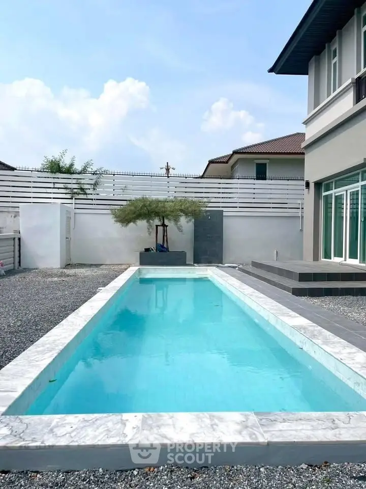 Luxurious modern home with sleek private pool and elegant exterior design.