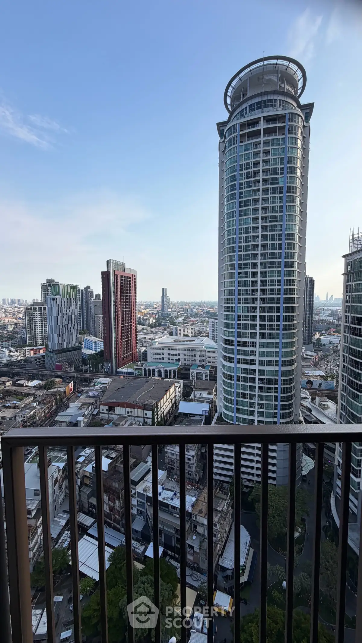 Stunning cityscape view from a high-rise balcony showcasing modern skyscrapers and urban landscape.