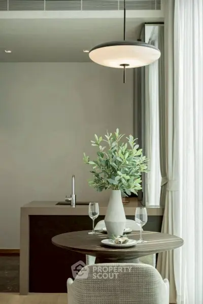 Modern kitchen with elegant dining setup and stylish lighting