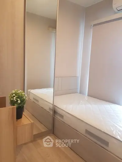 Cozy bedroom with mirrored wardrobe and natural light, perfect for a serene living experience.