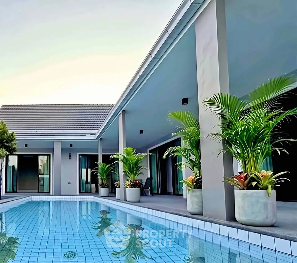 Luxurious modern villa with private pool and lush greenery, perfect for serene living.