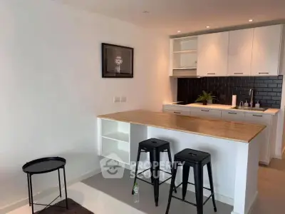 Modern kitchen with open layout and stylish black backsplash