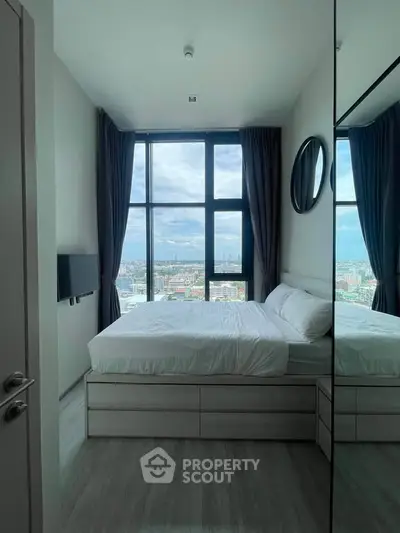 Modern bedroom with large window offering stunning city view, featuring sleek design and cozy ambiance.