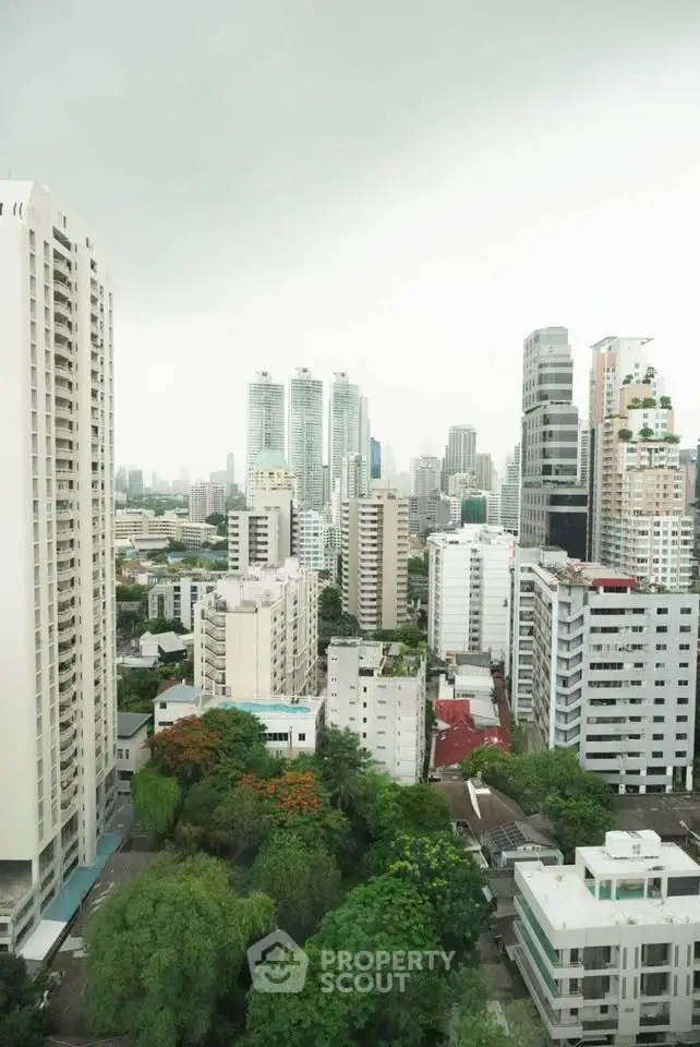 Stunning cityscape view of modern high-rise buildings and lush greenery, perfect for urban living enthusiasts.