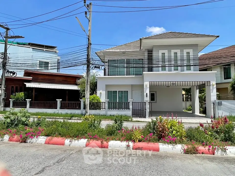Charming two-story house with modern design and spacious driveway in a serene neighborhood.
