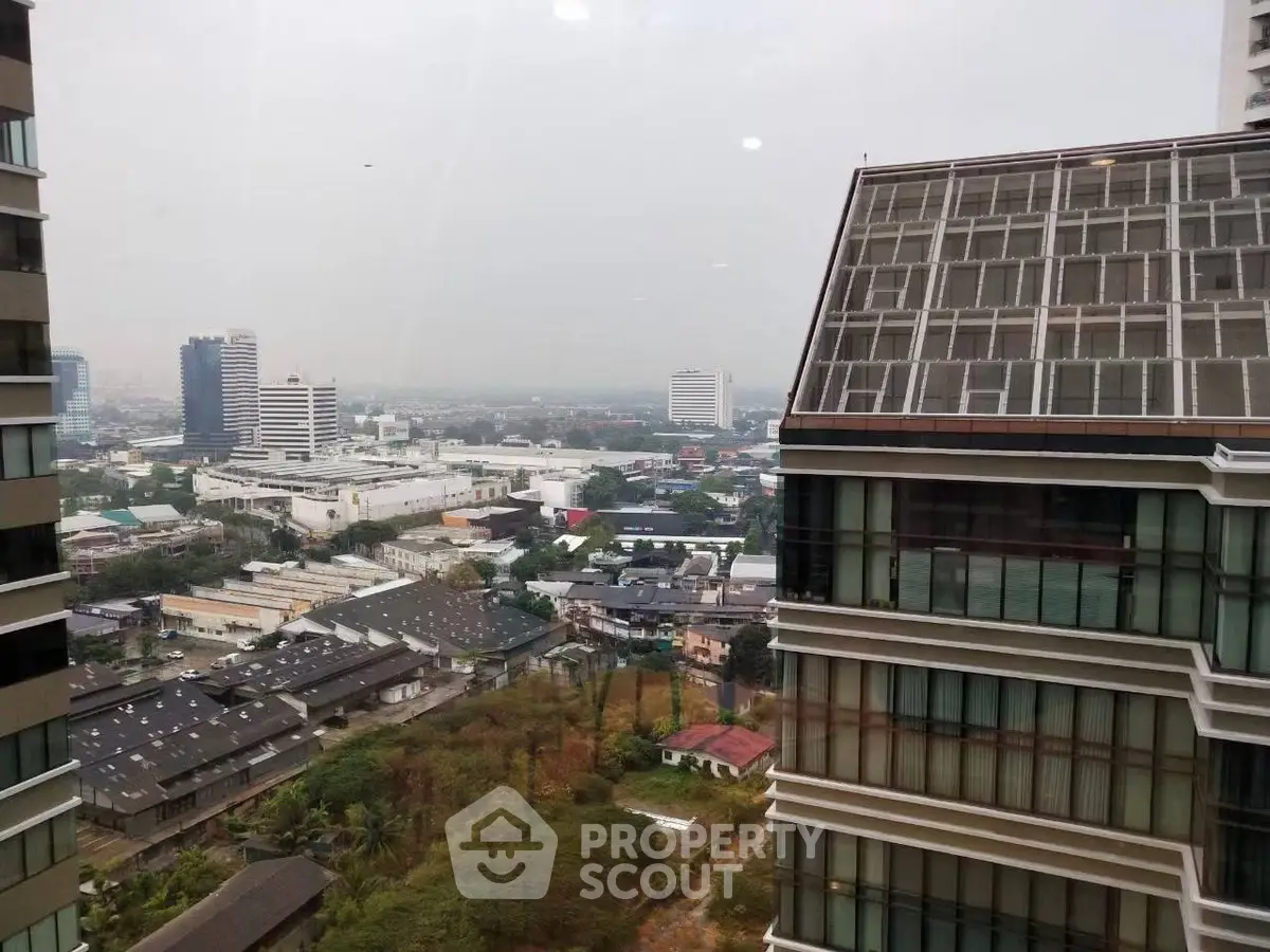Stunning cityscape view from high-rise building window, showcasing urban skyline and modern architecture.
