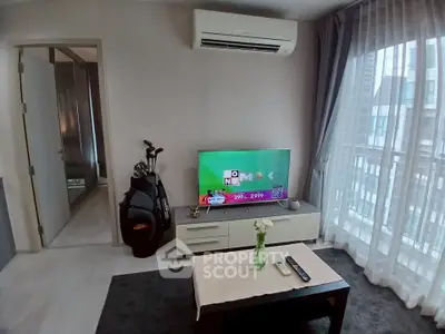 Modern living room with air conditioning and balcony view, featuring a sleek TV setup and elegant decor.