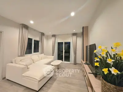 Spacious modern living room with elegant decor and large windows for natural light.