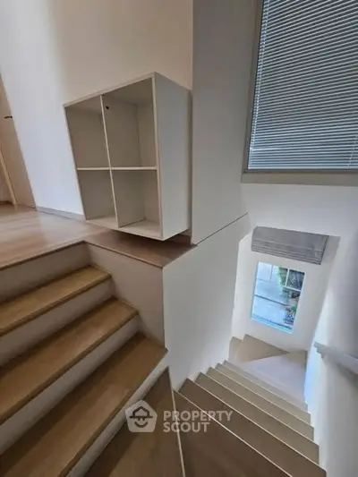 Modern staircase with sleek design and natural light