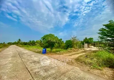 Expansive land plot with lush greenery and clear skies, ideal for development or investment opportunities.