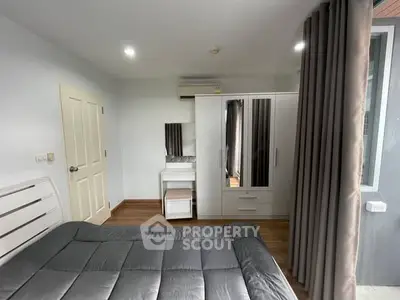 Modern bedroom with sleek furniture and ample natural light