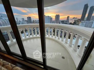 Stunning cityscape view from a luxurious curved balcony at sunset, perfect for urban living.