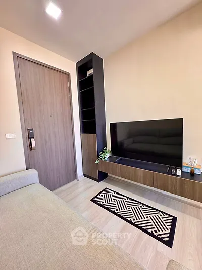 Modern living room with sleek TV unit and cozy seating area
