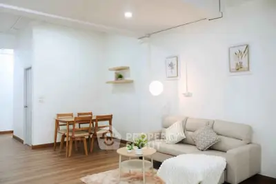 Modern living room with cozy sofa and dining area in stylish apartment.