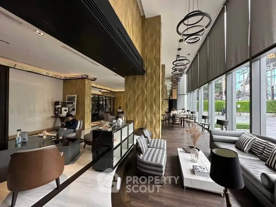 Luxurious modern lobby with stylish seating and floor-to-ceiling windows offering a serene garden view.