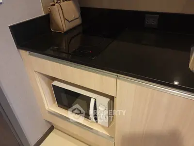 Modern kitchen with built-in microwave and electric cooktop