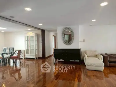 Spacious living room with polished wooden floors and elegant furniture