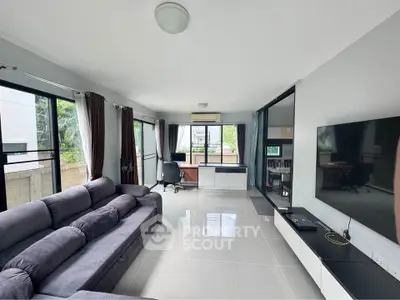 Spacious modern living room with sleek furniture and large windows