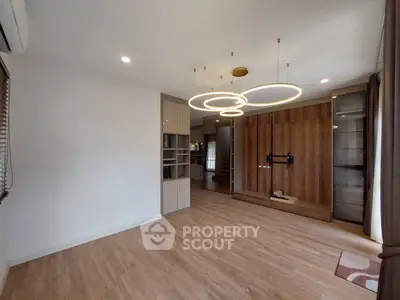 Spacious modern living room with elegant lighting and wooden flooring
