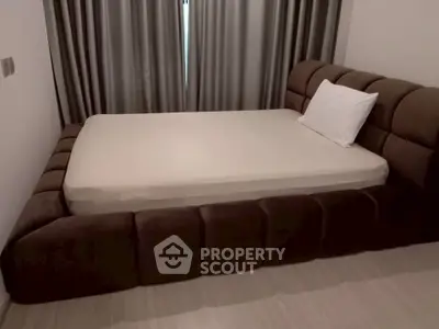 Modern bedroom with plush bed and elegant curtains