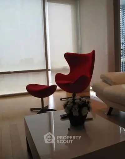 Stylish modern living room with iconic red chair and sleek decor