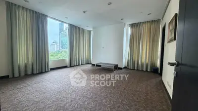 Spacious corner unit with large windows offering city views, perfect for a modern living room setup.