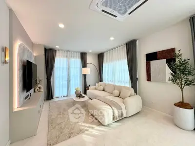 Elegant modern living room with cozy white sofa, stylish decor, and large windows for natural light.