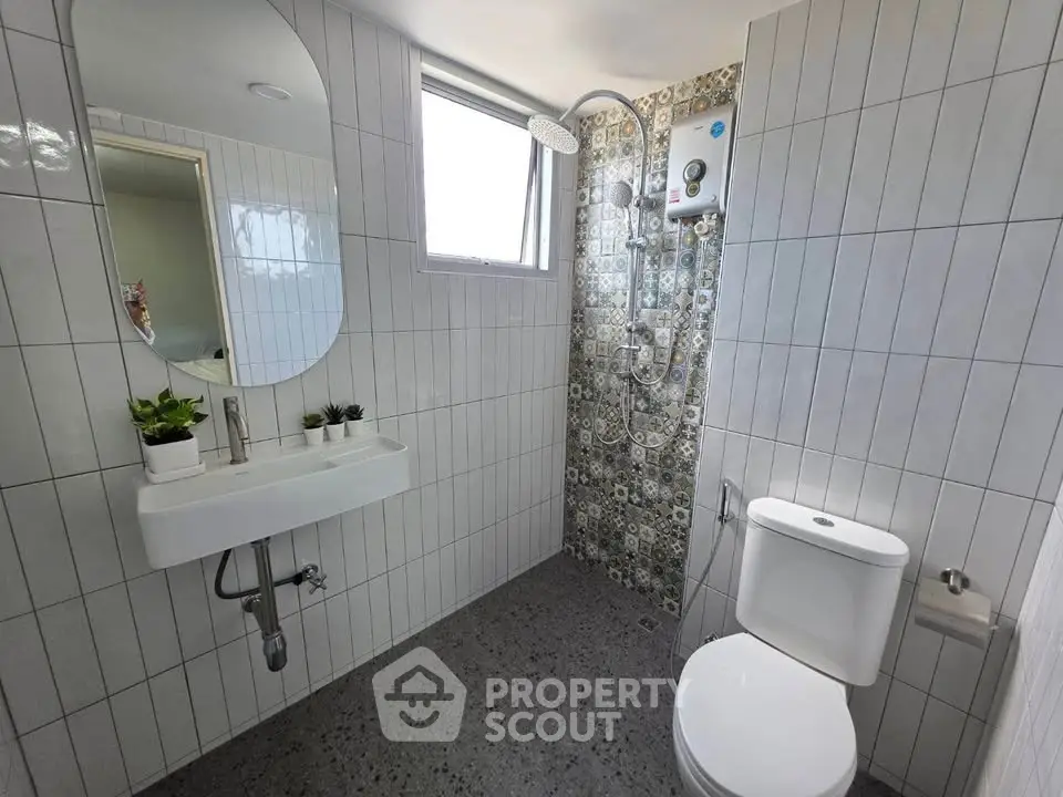 Modern bathroom with stylish tiles and natural light