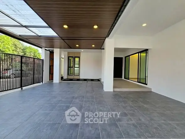 Spacious modern entrance with sleek tile flooring and elegant lighting