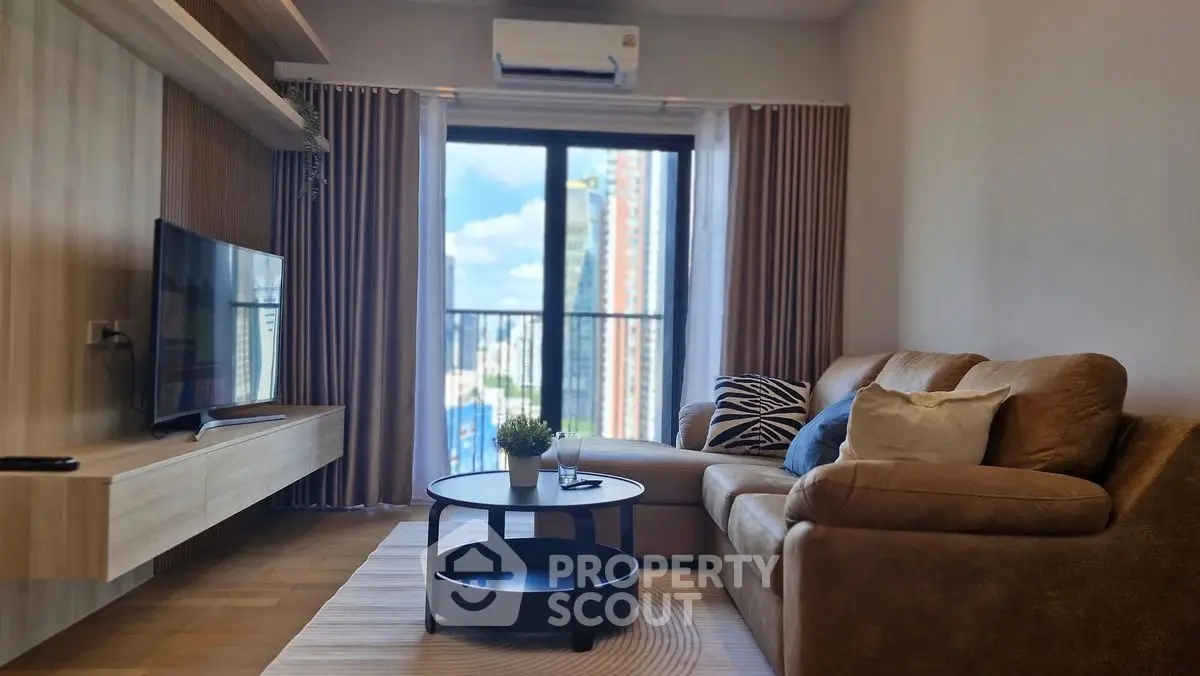 Modern living room with cozy sofa and city view balcony, perfect for urban living.